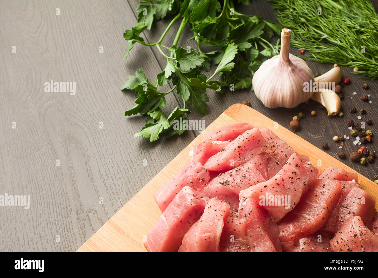 Juicy raw meat with spices, pepper, sea salt and herbs lies on a Stock Photo Alamy