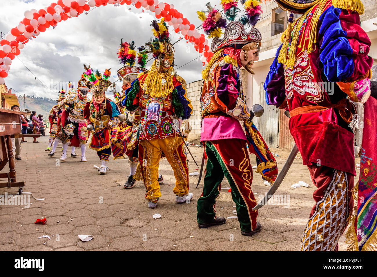 Parramos, Guatemala - December 29, 2016: Traditional folk dancers in masks & costumes perform Dance of the Moors & Christians in village near Antigua. Stock Photo