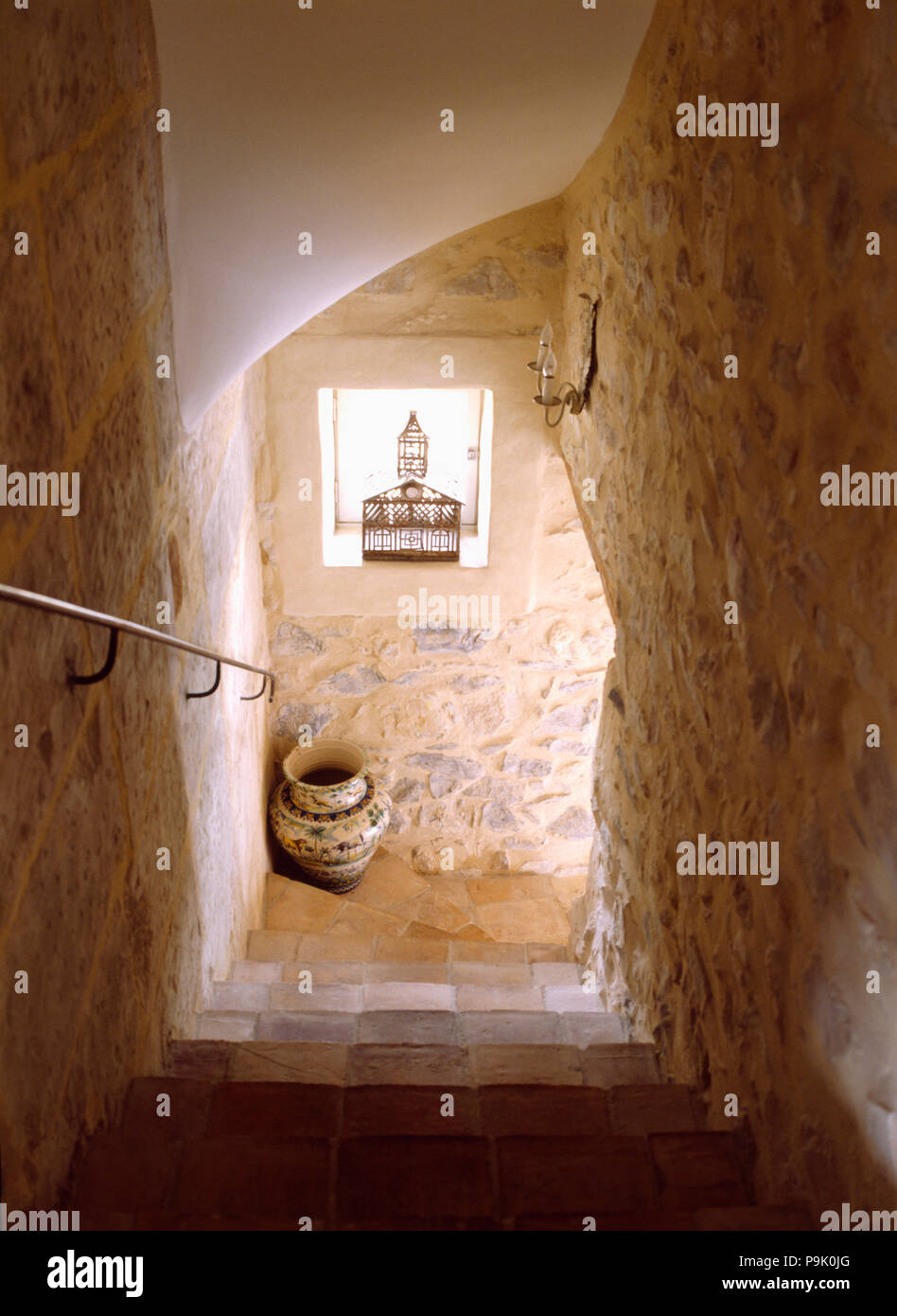 Rough stone walls above staircase in Provencal house Stock Photo