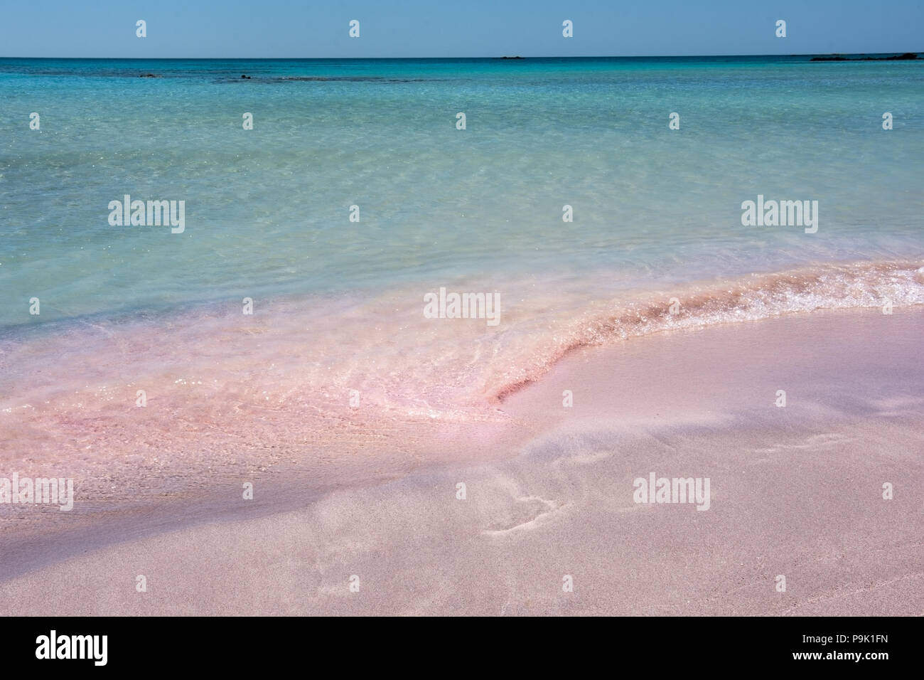 Pink fine sand beach at the turquoise sea in summer Stock Photo