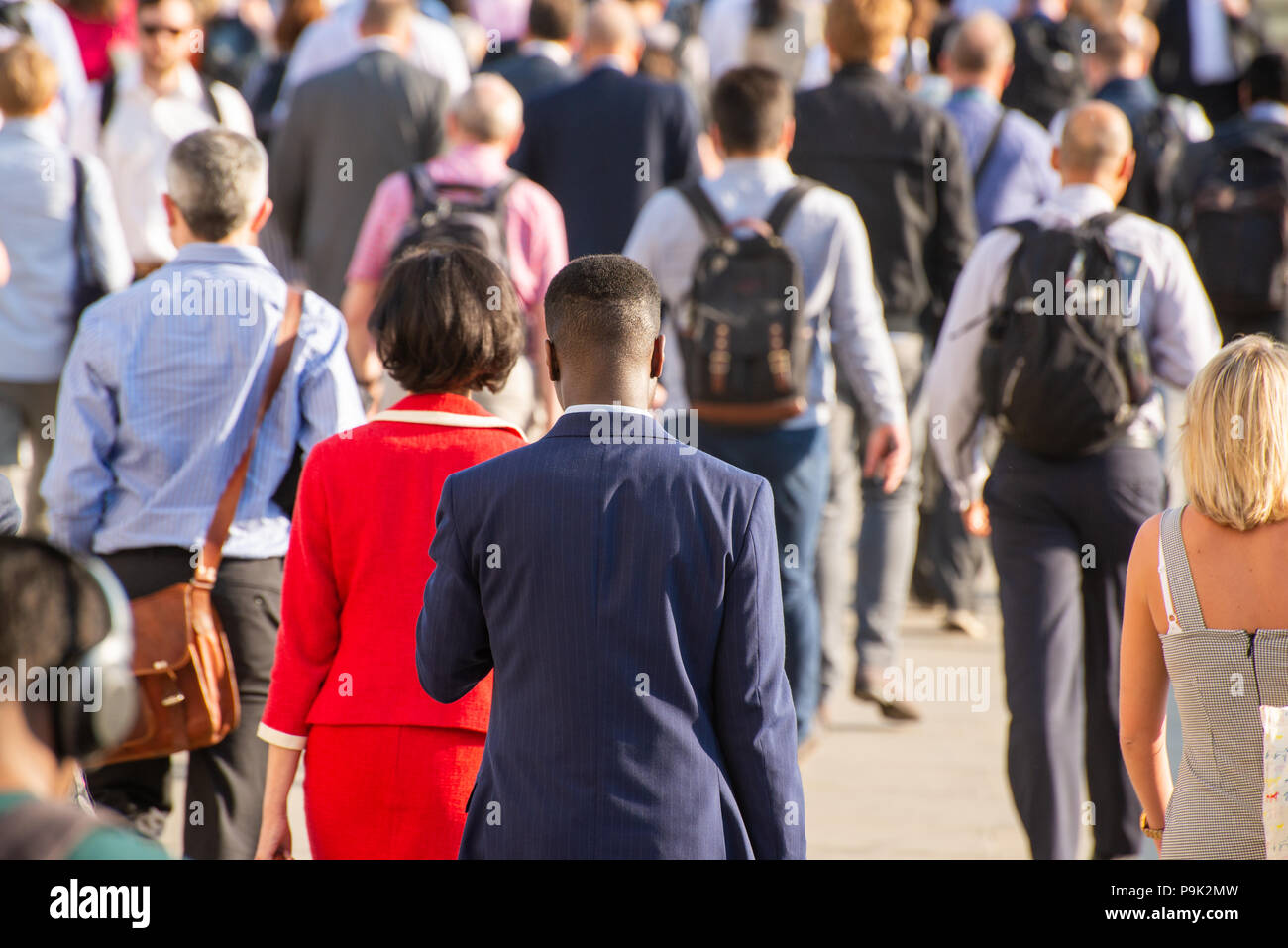 Commuters crossing London Bridge, London, UK Stock Photo
