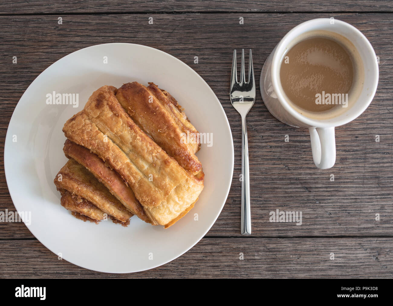 top view of Franzbroetchen pastry on plate on rustic wooden table Stock Photo