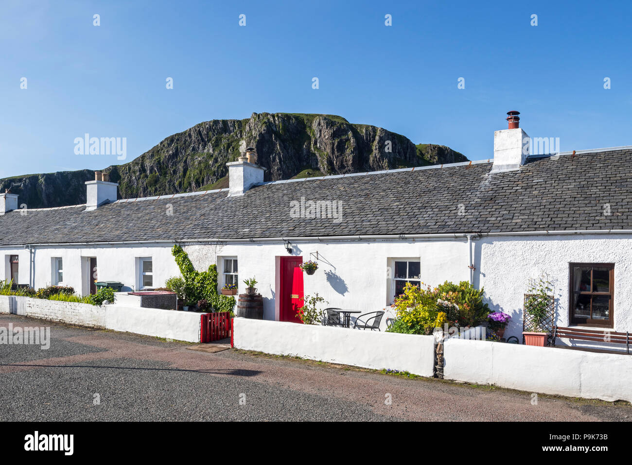 Row of white-harled workers cottages in former slate-mining village Ellenabeich on the isle of Seil, Argyll and Bute, Scotland, UK Stock Photo