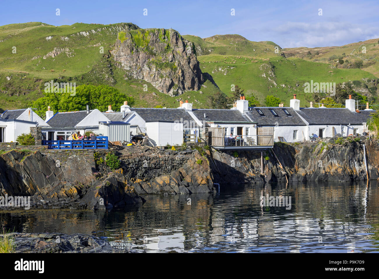 Row of white-harled workers cottages in former slate-mining village Ellenabeich on the isle of Seil, Argyll and Bute, Scotland, UK Stock Photo