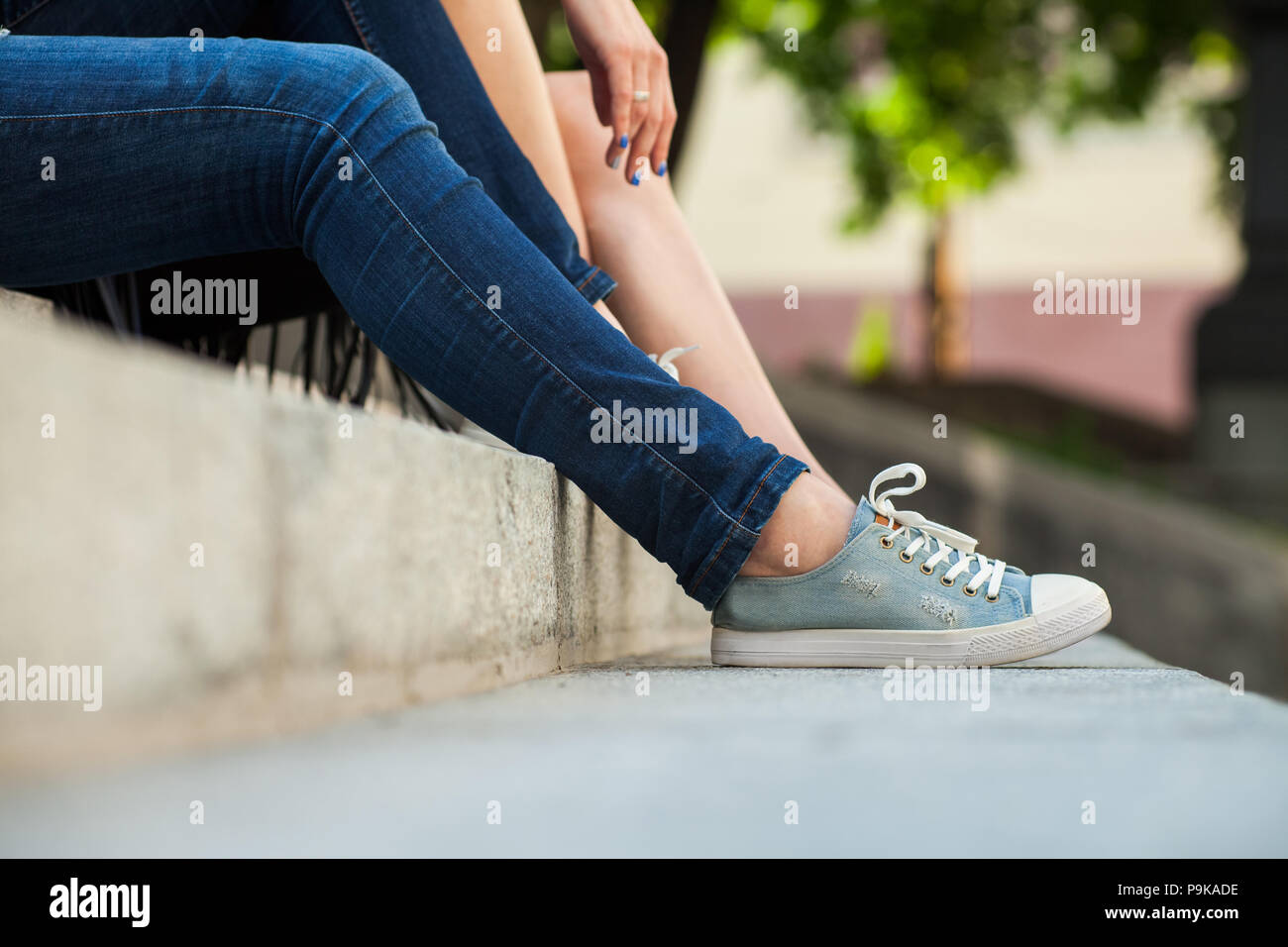 women wearing sneakers sitting on stairs Stock Photo - Alamy
