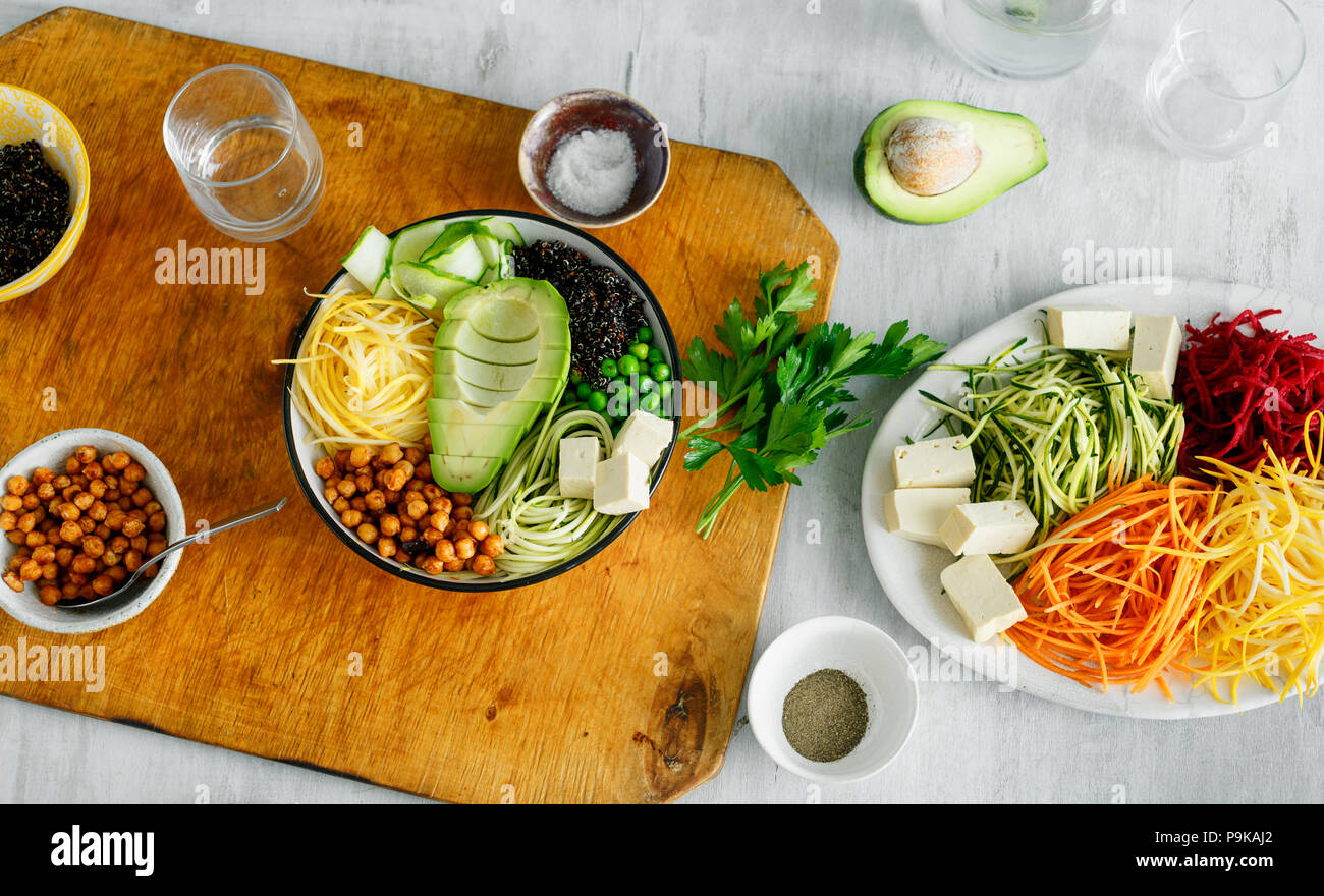 Healthy food clean eating. Bowl of buddha with spiralized vegetables on white wooden table, top view Stock Photo