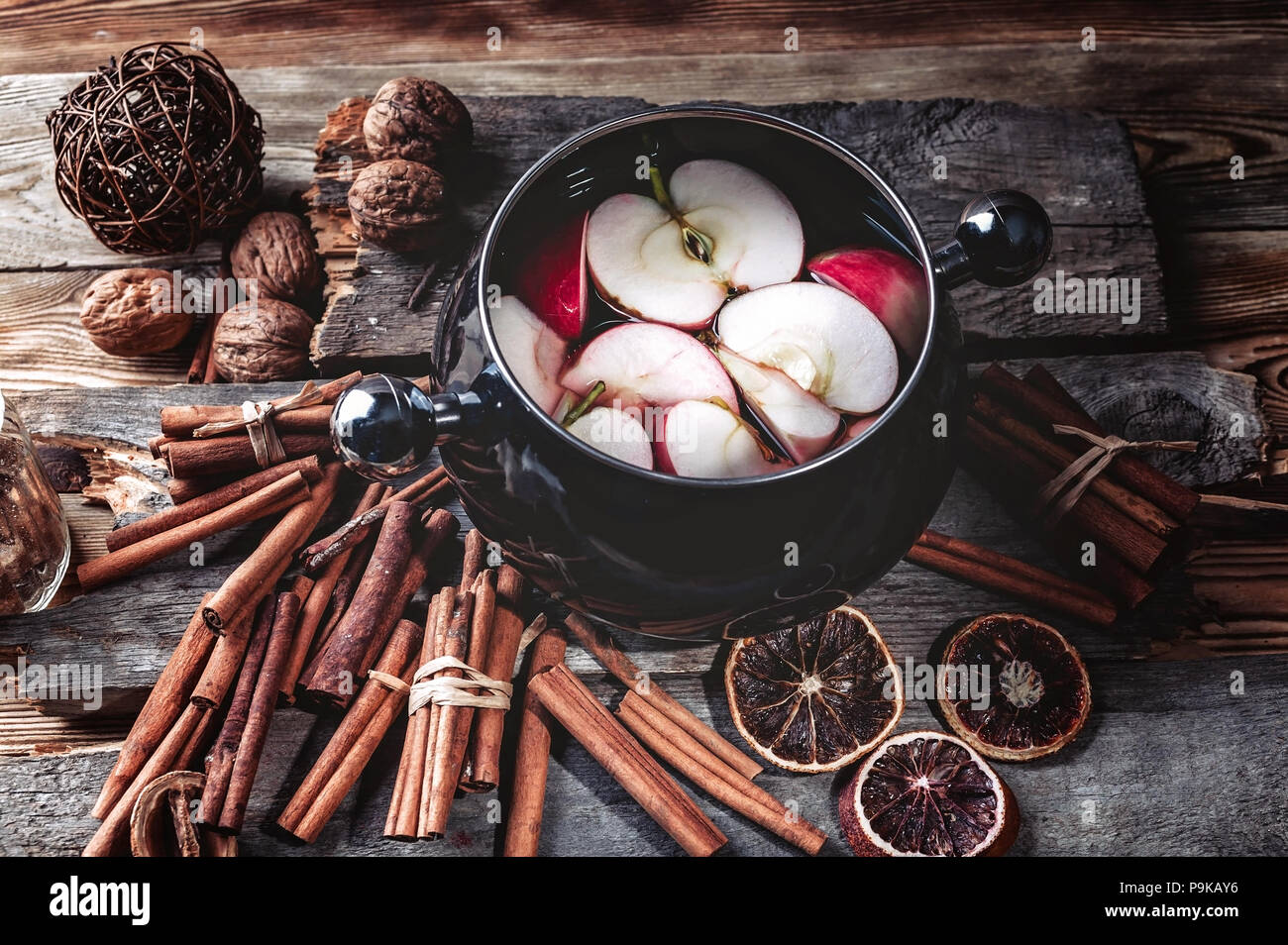 Red apples in red wine. Traditional winter mulled wine. Spices and