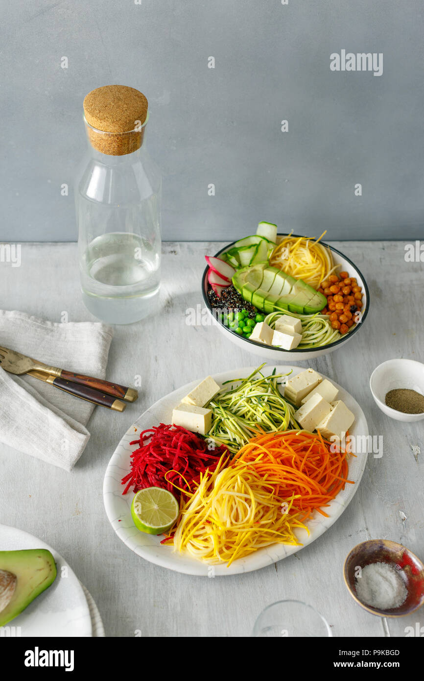 Healthy food clean eating. Spiralized vegetables with bowl of buddha on white wooden table Stock Photo