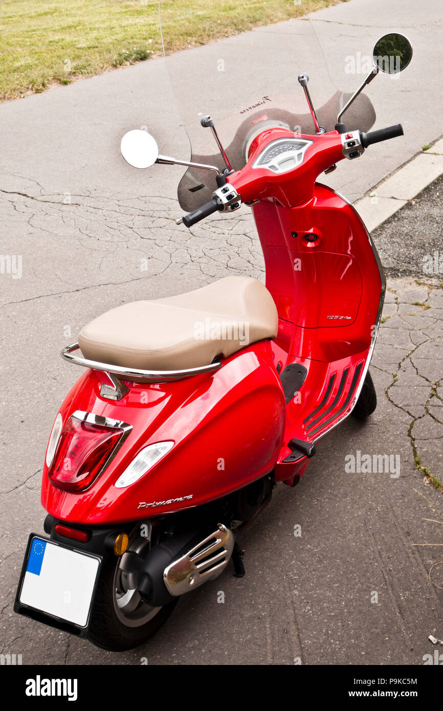 red scooter Vespa Primavera parked on the street Stock Photo - Alamy