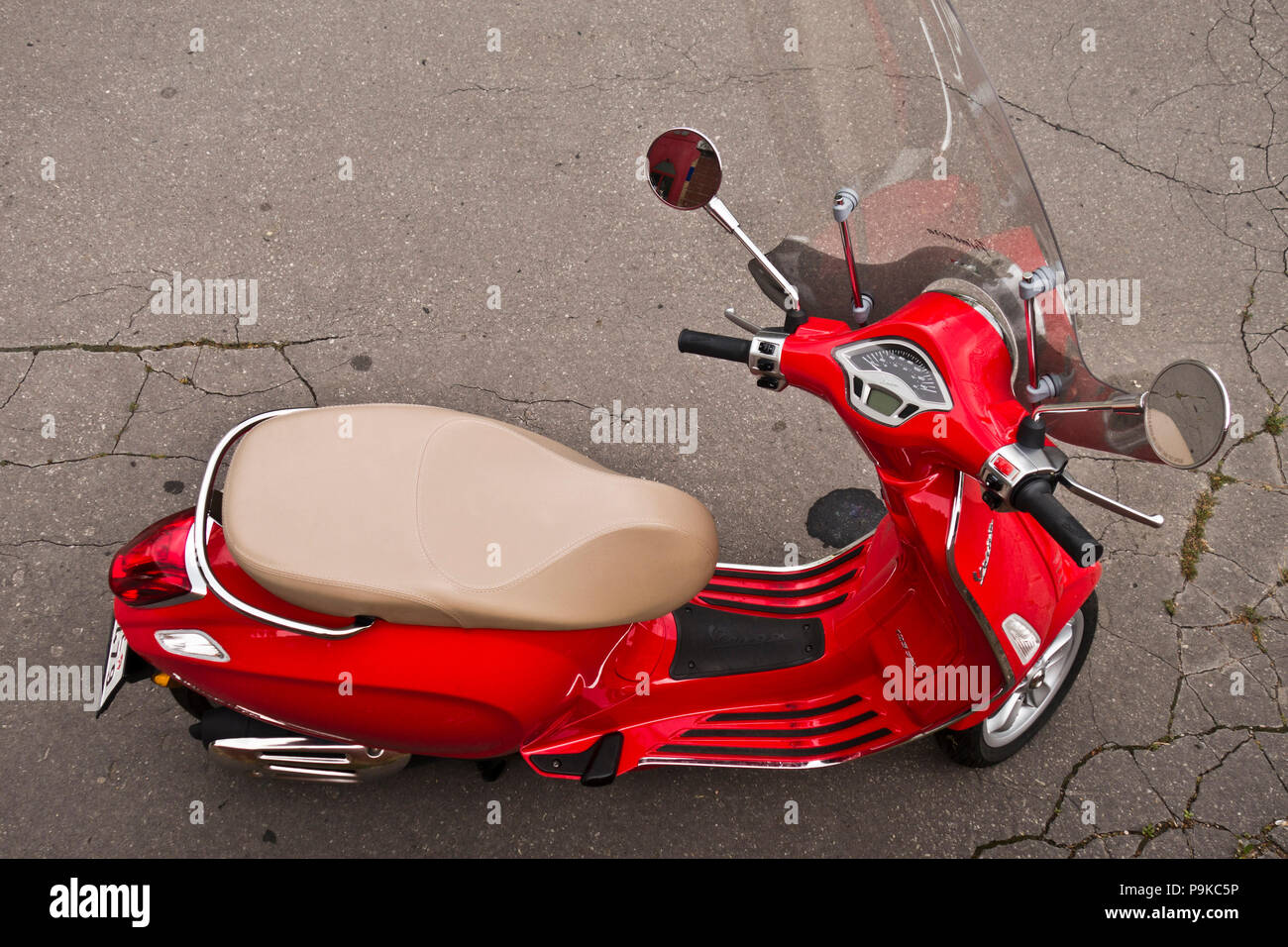 red scooter Vespa Primavera parked on the street Stock Photo - Alamy