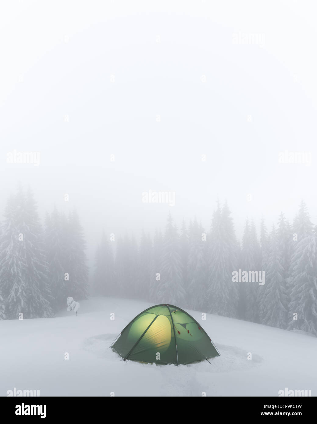 Green tent lighted from the inside Stock Photo