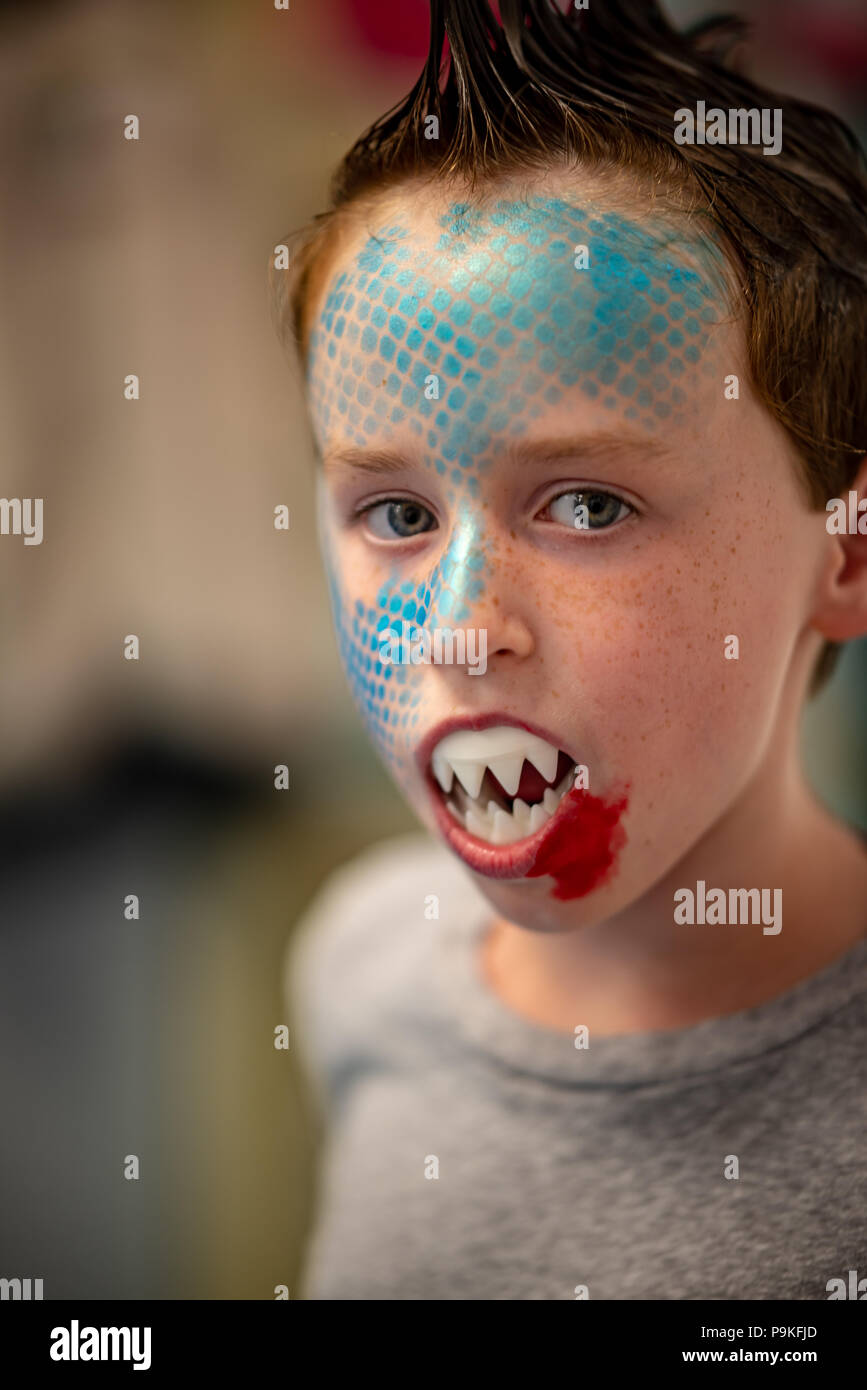 Boy with face painted like a shark Stock Photo