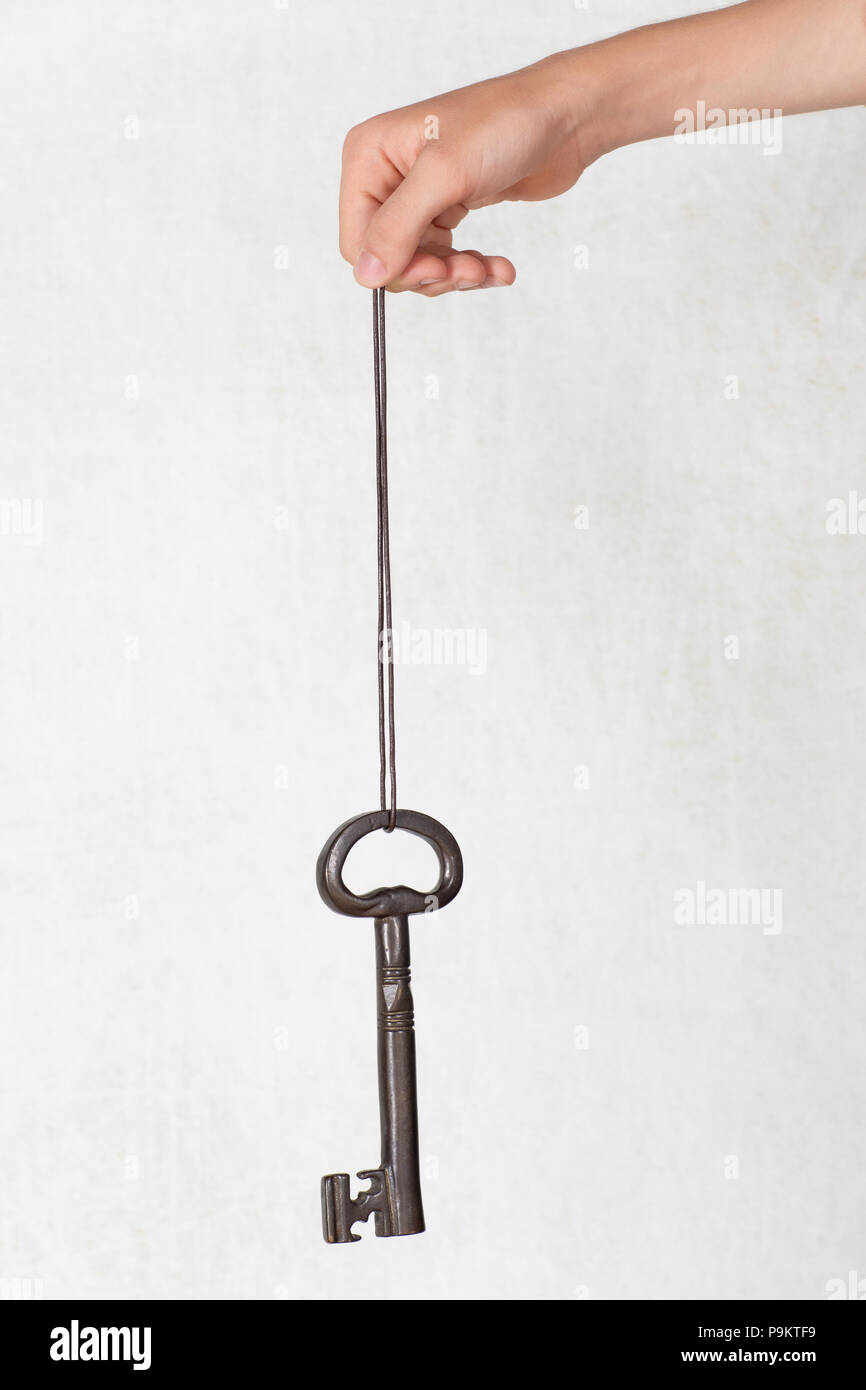 Big key hanging on a string, security concept Stock Photo Alamy