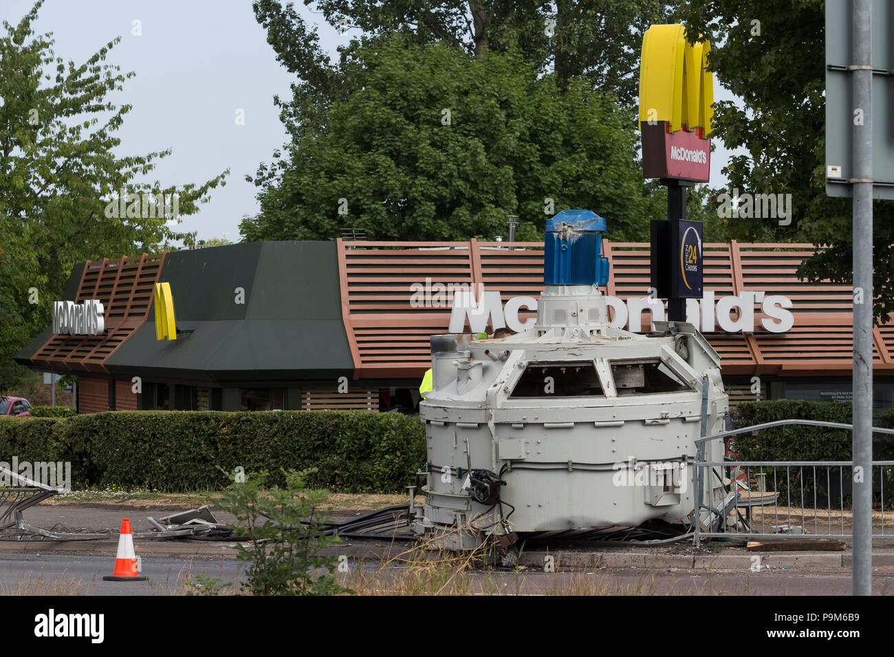 A50, Uttoxeter, Staffordshire, UK. 19th July 2018. A cement mixer which has fallen from a lorry on the side of the road on the McDonalds roundabout, A50, Uttoxeter. Credit: Richard Holmes/Alamy Live News Stock Photo