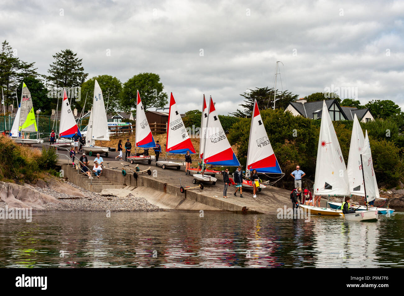 Schull, West Cork, Ireland. 19th July, 2018. Young people come from all over the island of Ireland, including the North, to take part in the schools regatta which is aimed at novice racing sailors. The fleet is pictured launching from the Schull Sailing Centre slipway. Credit: Andy Gibson/Alamy Live News. Stock Photo