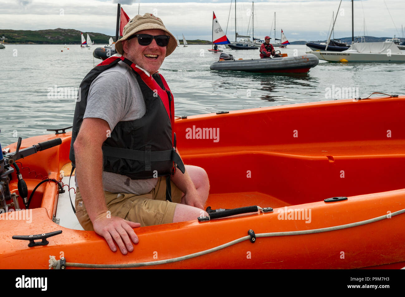 Schull, West Cork, Ireland. 19th July, 2018. Young people come from all over the island of Ireland, including the North, to take part in the schools regatta which is aimed at novice racing sailors. Ken Philpott from Northern Ireland manned a safety boat. Credit: Andy Gibson/Alamy Live News. Stock Photo