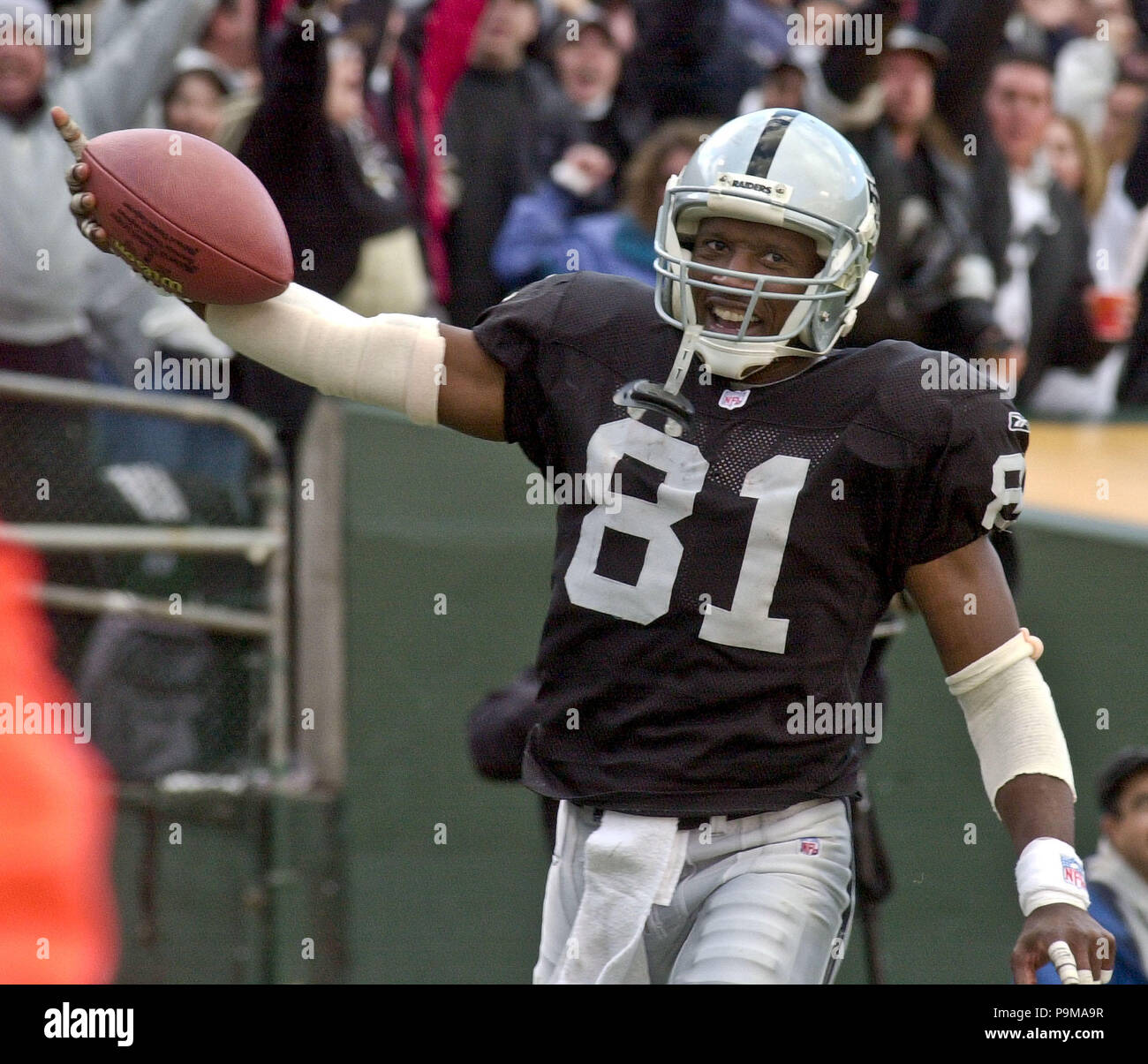 Oakland, California, USA. 9th Dec, 2001. Oakland Raiders wide receiver Tim  Brown (81) makes his 100th touchdown on an 88-yard punt return on Sunday,  December 9, 2001, in Oakland, California. The Raiders