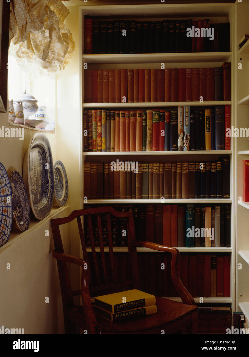 Books on floor to ceiling shelves on cottage landing Stock Photo Alamy