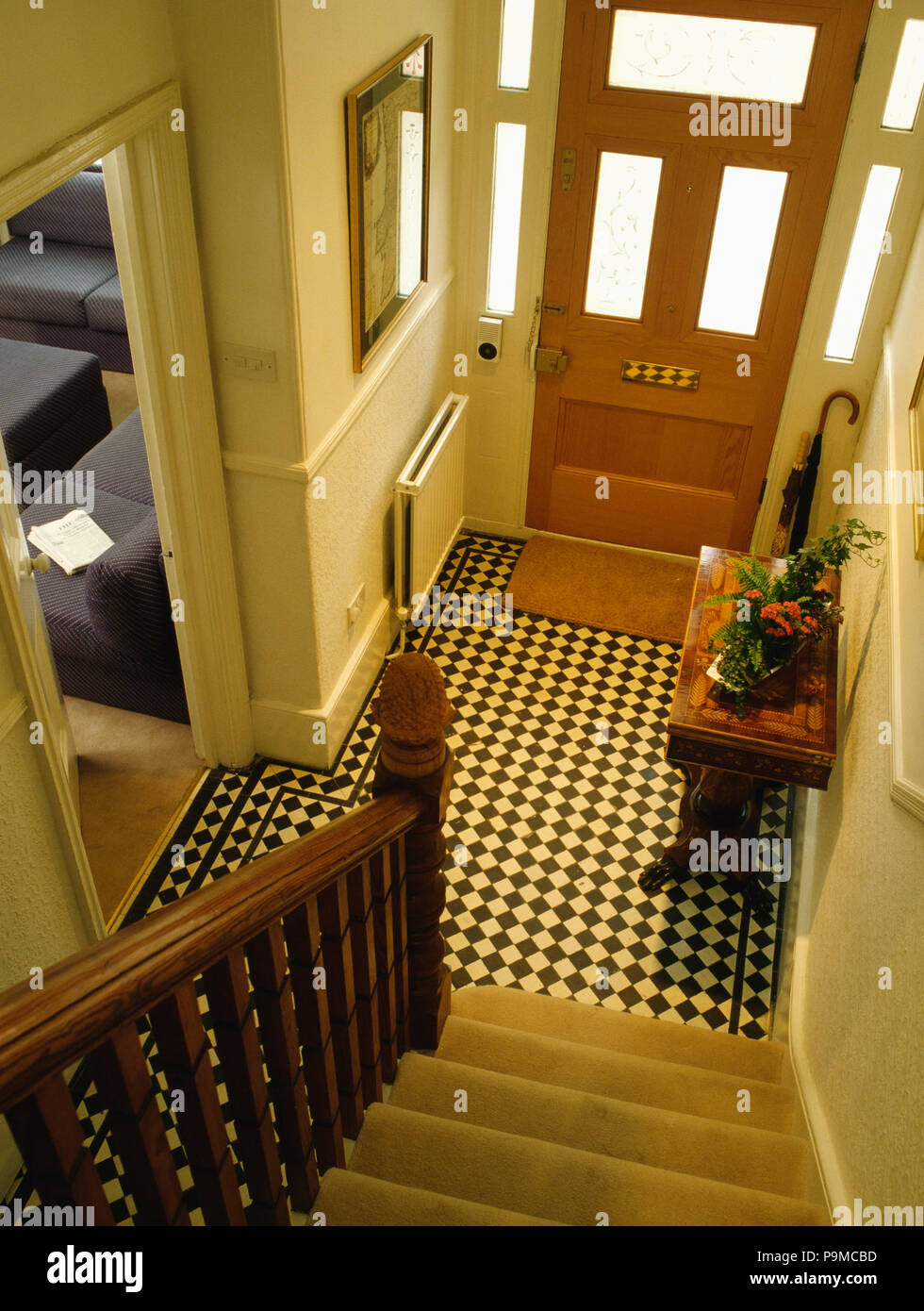 Birdseye view of black+white encaustic tiles in townhouse hall with glazed panels in front door Stock Photo