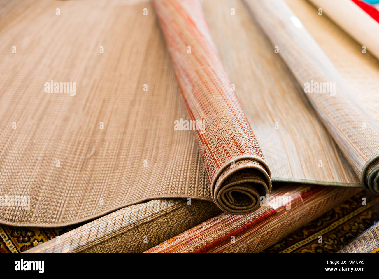 image of different straw carpets in the shop for decoration Stock Photo