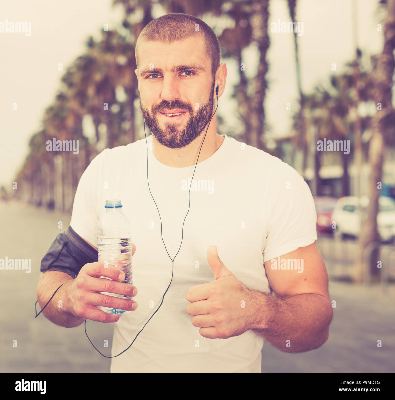 Athletic male stopped to rest while running Stock Photo Alamy
