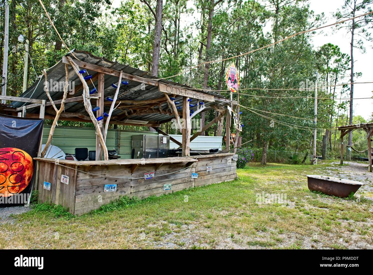 An old rustic outdoor bar sits among the forest Stock Photo - Alamy