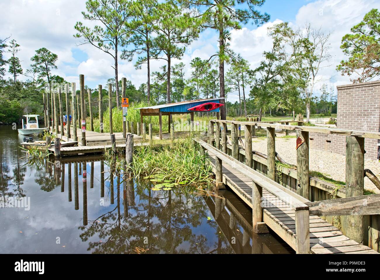 View of a wooden dock along a lagoon at Old Fort Bayou Ocean Springs