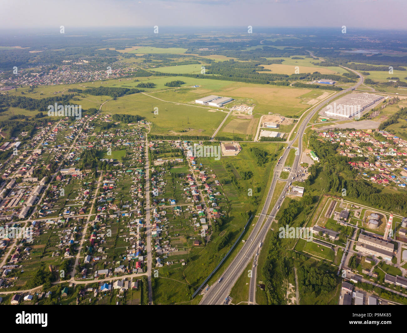 Helicopter drone shot. View from above on a small village, motor road ...