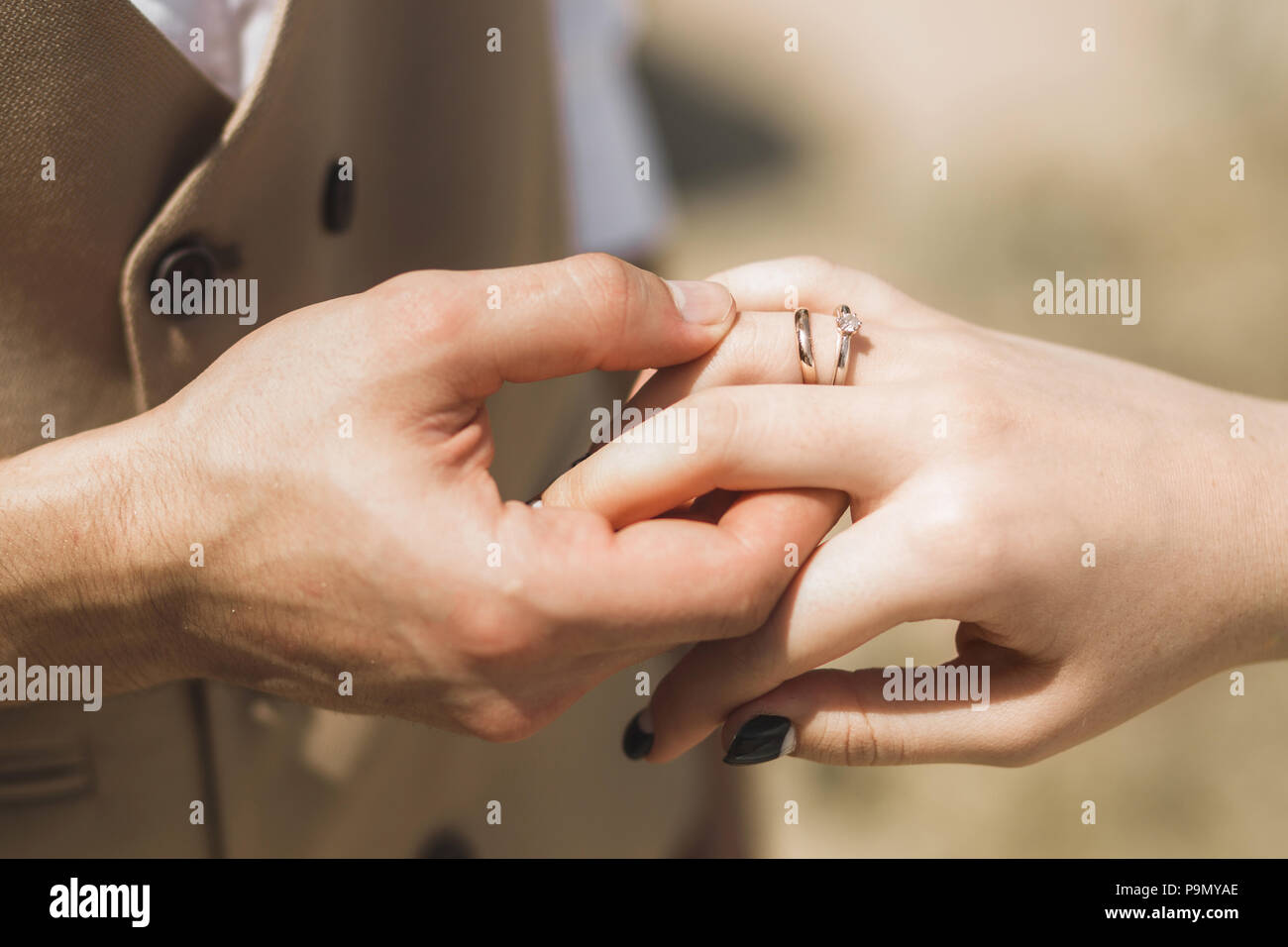 Groom wearing ring on bride s hand on wedding ceremony close up