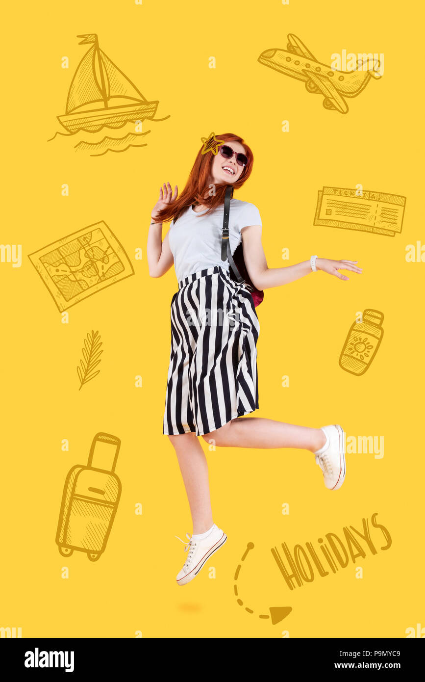 Positive teacher jumping while being on holidays Stock Photo
