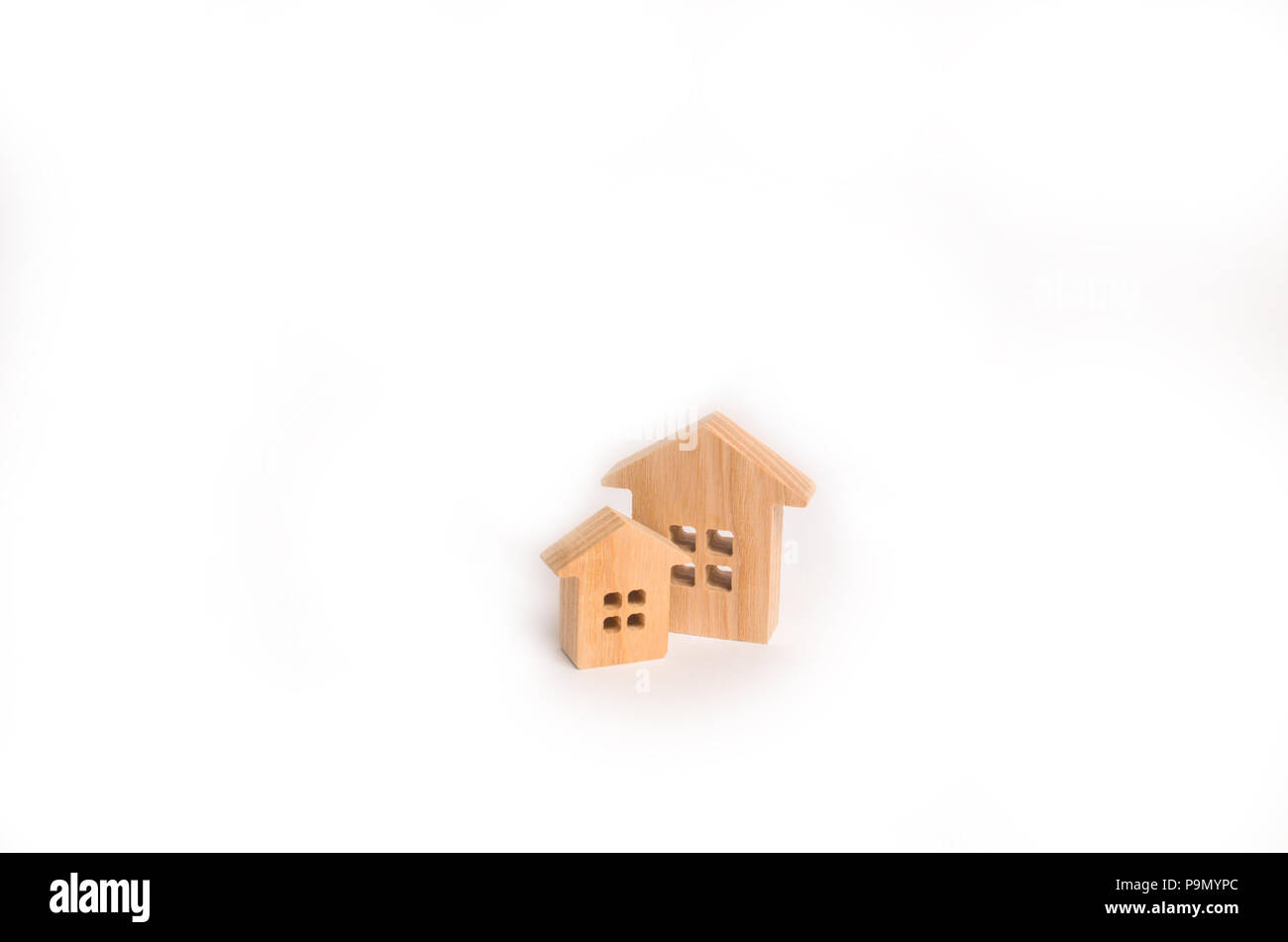 Investments, insurance and construction of housing and business. Two wooden houses on a white background. Concept of real estate, buying and selling.  Stock Photo