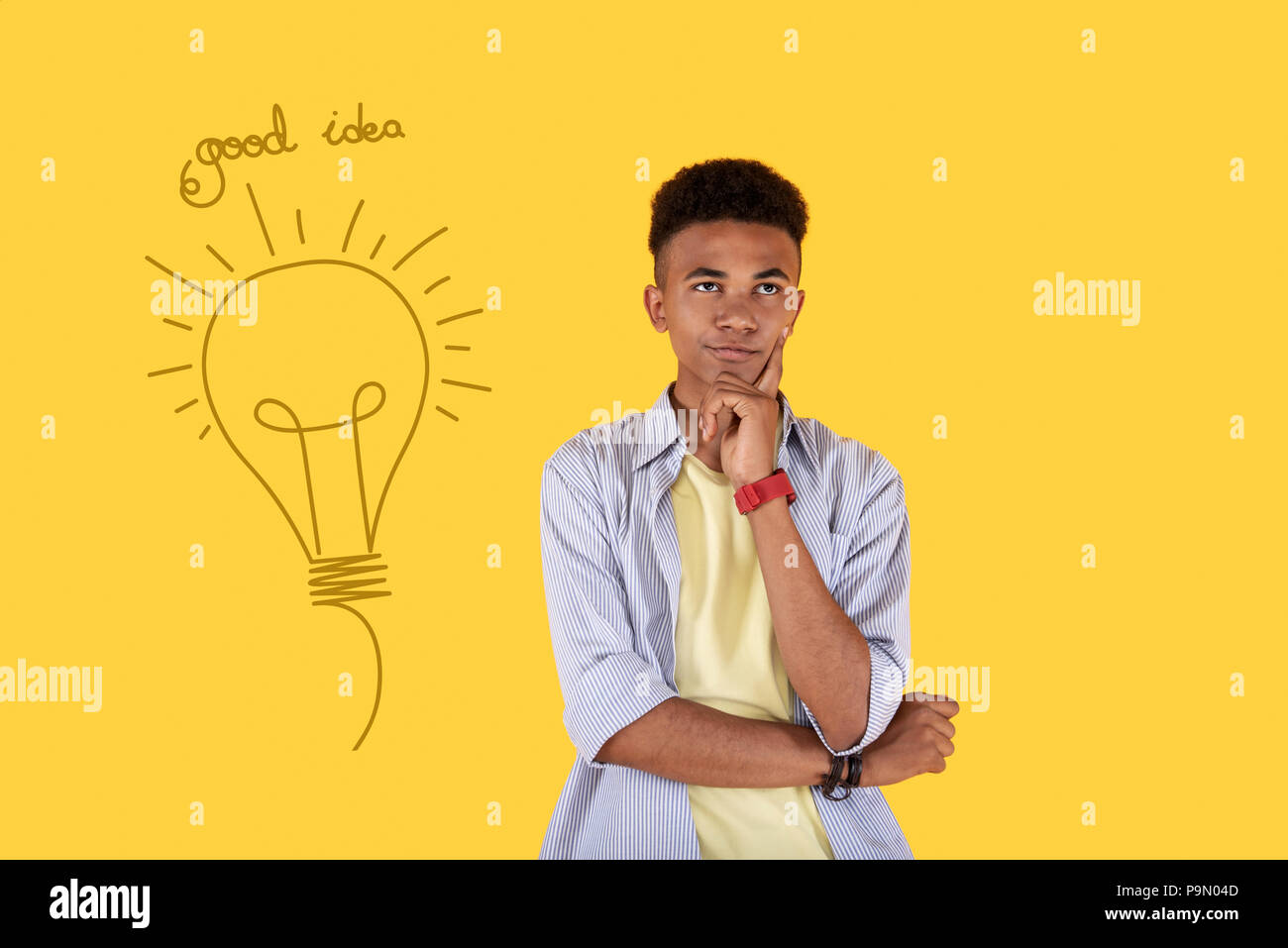 Guy Getting Idea Creative student thoughtfully touching his face while getting an idea ...