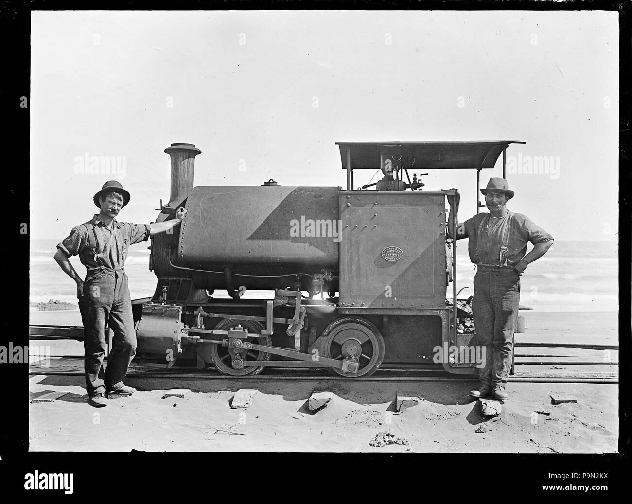 303 Steam railway locomotive the &quot;Sandfly&quot; with her driver and  fireman standing beside, on the Karekare beach tramway. ATLIB 286760 Stock  Photo - Alamy