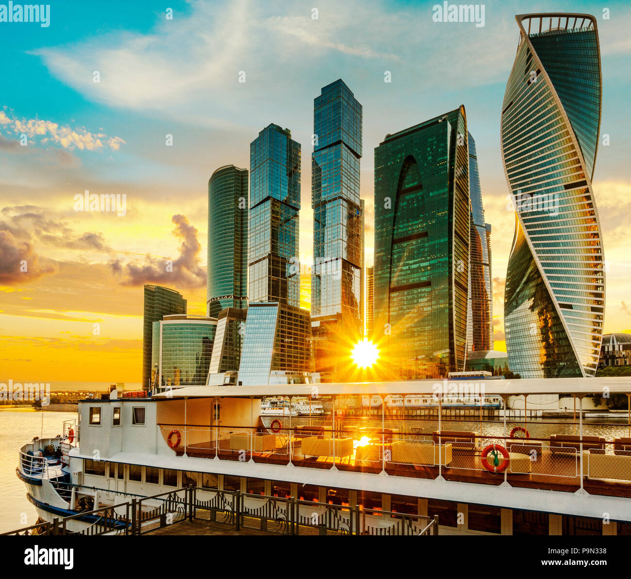 View of Moscow international business center (Moscow city) and pleasure boat against the setting sun, Russia Stock Photo