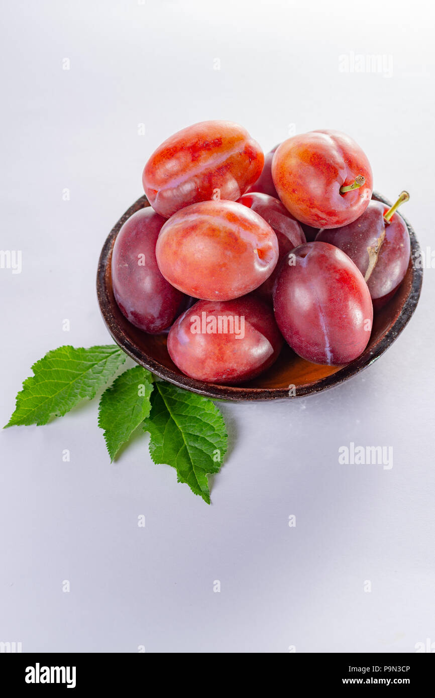 Group of ripe oval Victoria plums from England on white background with leaves Stock Photo Alamy