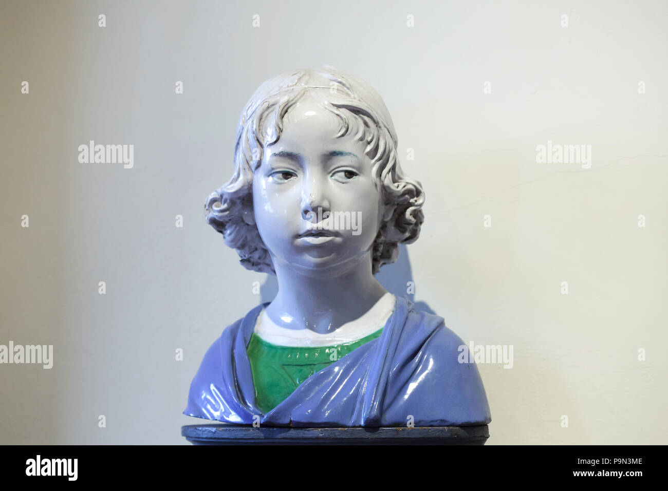 Portrait of a Boy. Glazed terracotta bust by Italian Renaissance sculptor Andrea della Robbia (ca. 1475-1480) on display in the Bargello Museum (Museo Nazionale del Bargello) in Florence, Tuscany, Italy. Stock Photo