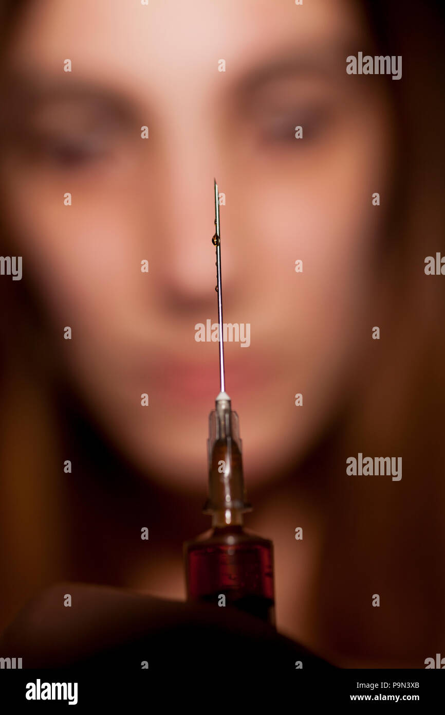 A girl with syringe. Drugs addiction concept Stock Photo Alamy