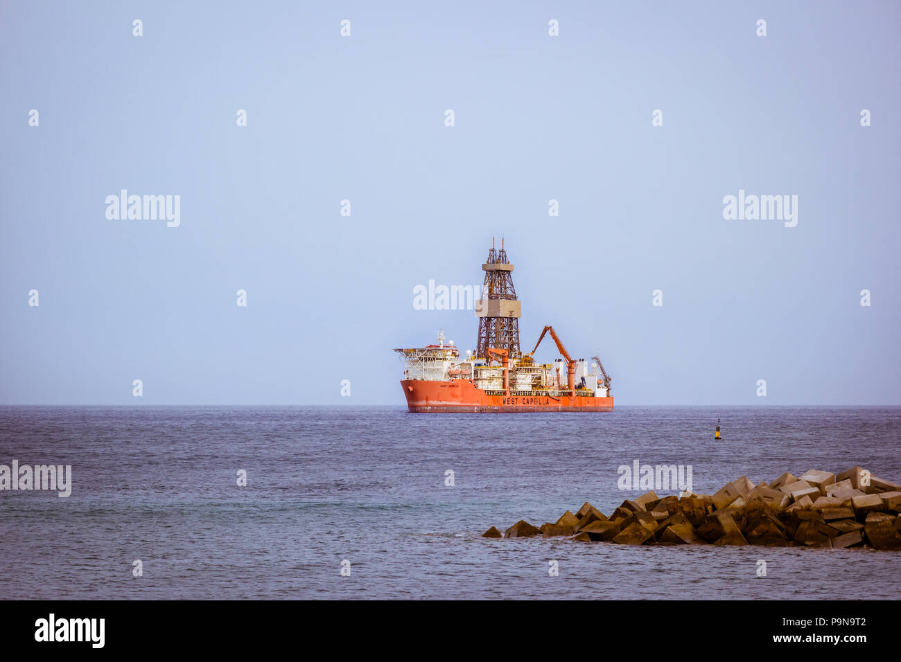 A 10,000 design ultra deepwater drillship rig in the Atlantic Ocean passes the coast of Tenerife