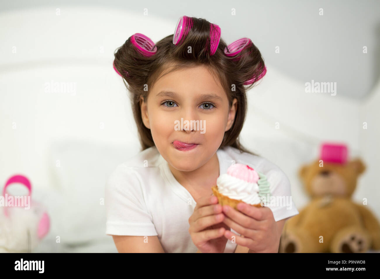 Cute girl eating cupcake Stock Photo Alamy