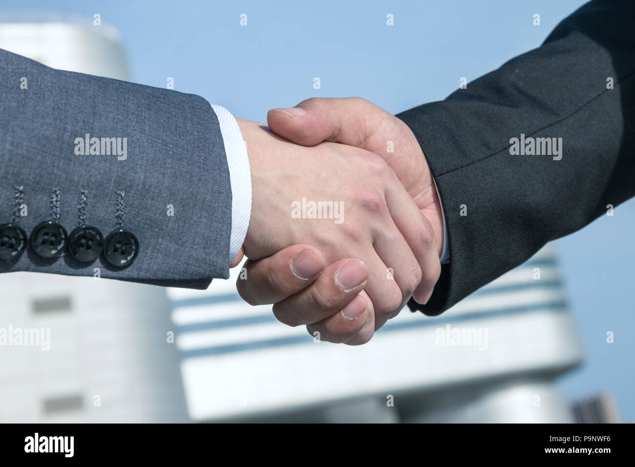 Asian business people shaking hands Stock Photo