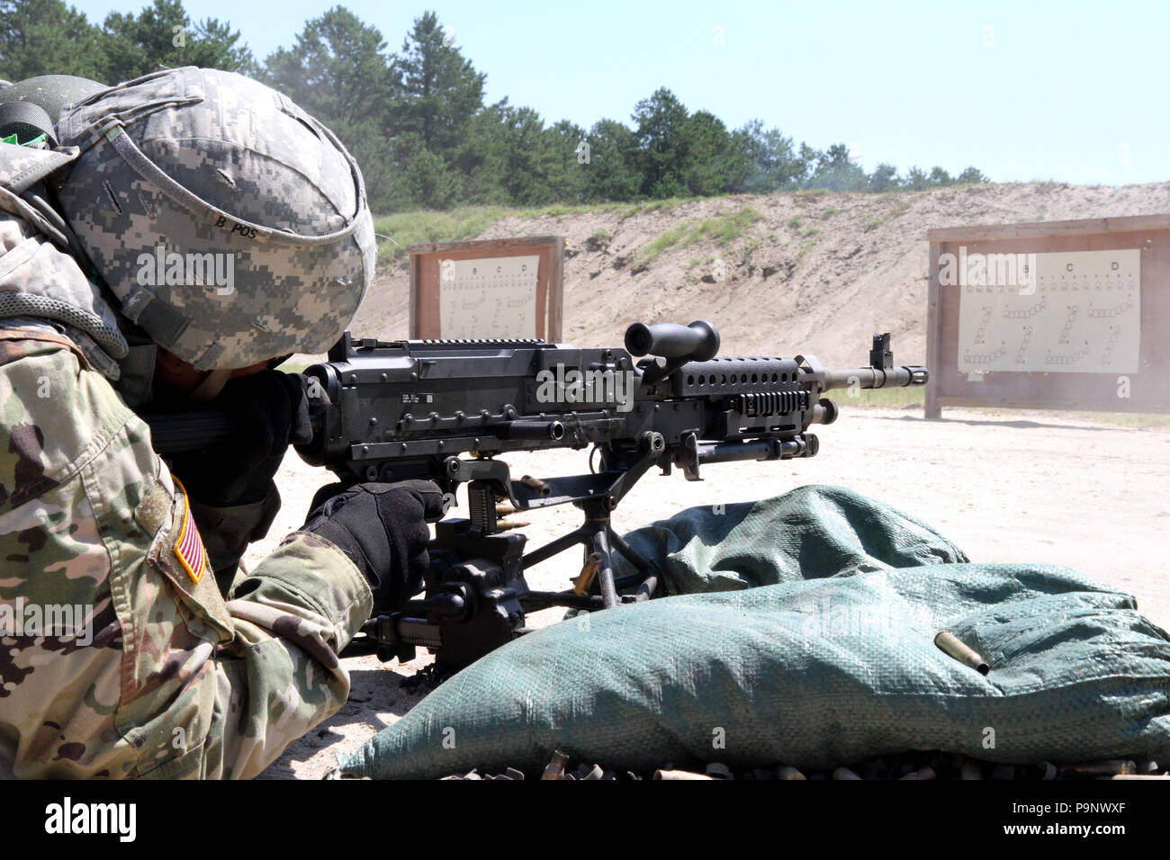 Brass ammunition shells eject quickly as a U.S. Army Reserve Soldier fires her weapon while qualifying on the M249 light machine gun during Operation Cold Steel II, hosted by the U.S. Army Civil Affairs and Psychological Operation Command at Joint Base McGuire-Dix-Lakehurst, N.J., July 11, 2018. Operation Cold Steel is the U.S. Army Reserve’s crew-served weapons qualification and validation exercise to ensure that America’s Army Reserve units and Soldiers are trained and ready to deploy on short notice and bring combat-ready and lethal firepower in support of the Army and our joint partners an Stock Photo