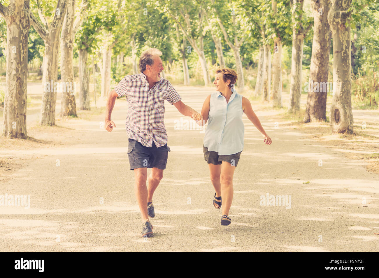 Happy beautiful senior couple in love walking and holding hands in the ...