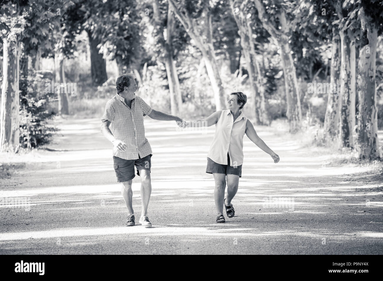 Happy beautiful senior couple in love walking and holding hands in the ...