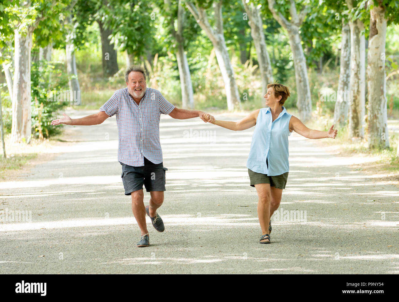 Happy beautiful senior couple in love walking and holding hands in the ...