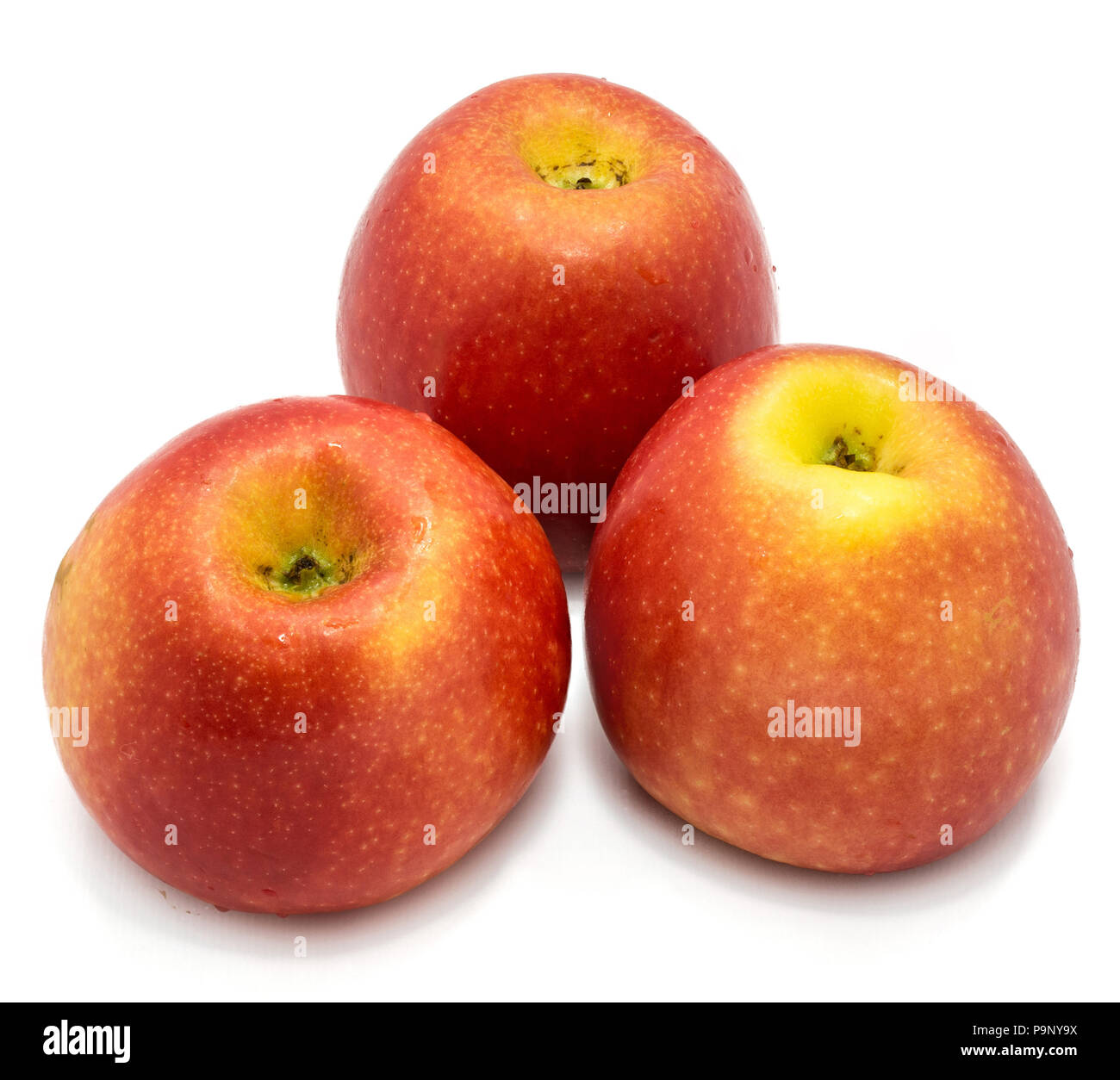 Three whole red Kanzi apples isolated on white background Stock Photo