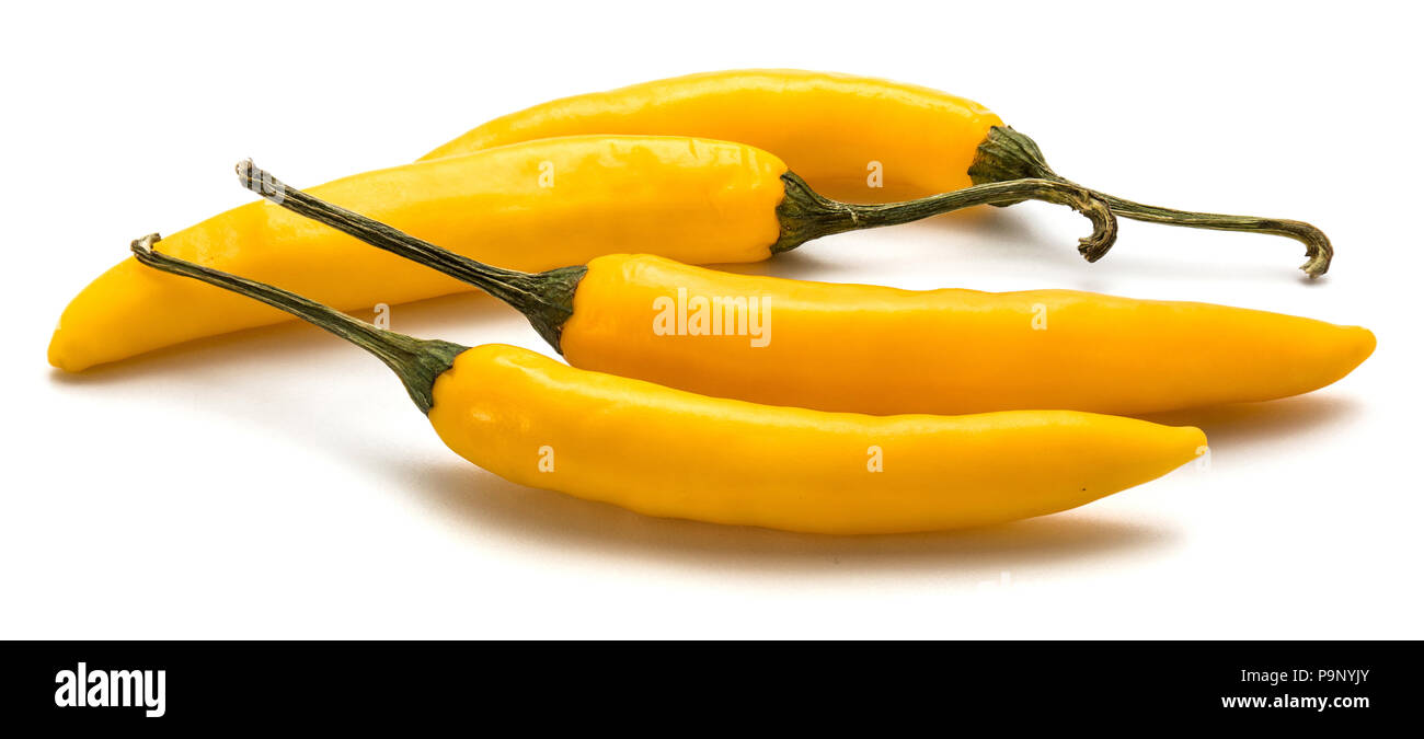 Four yellow Chili peppers isolated on white background Stock Photo - Alamy