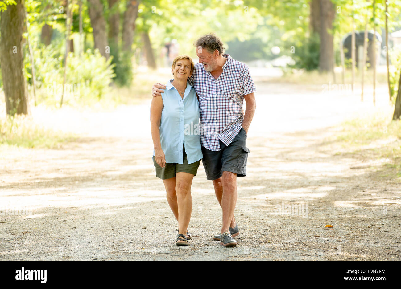 Happy beautiful senior couple in love walking and holding hands in the ...