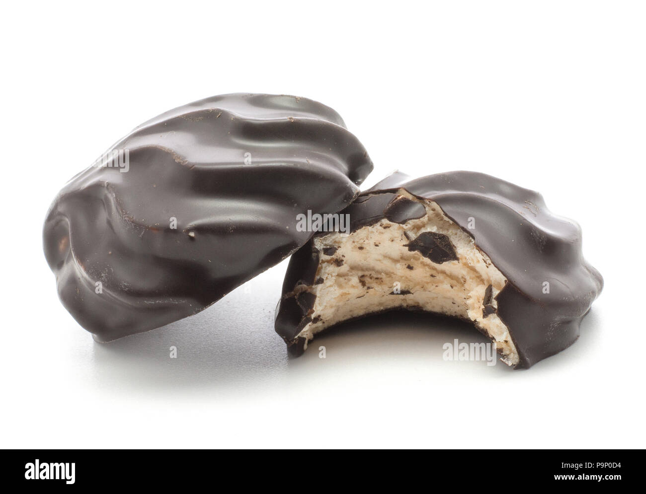 Two dark chocolate-coated zefir isolated on white background one bitten Stock Photo