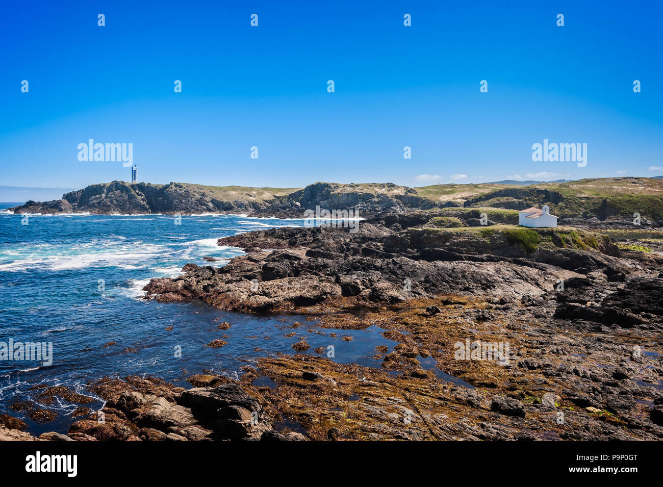 The hermitage of the Virgen del Puerto in Meirás, A Coruna, Galicia, Spain.Landscape of the coast of Galicia, lighthouse. Stock Photo