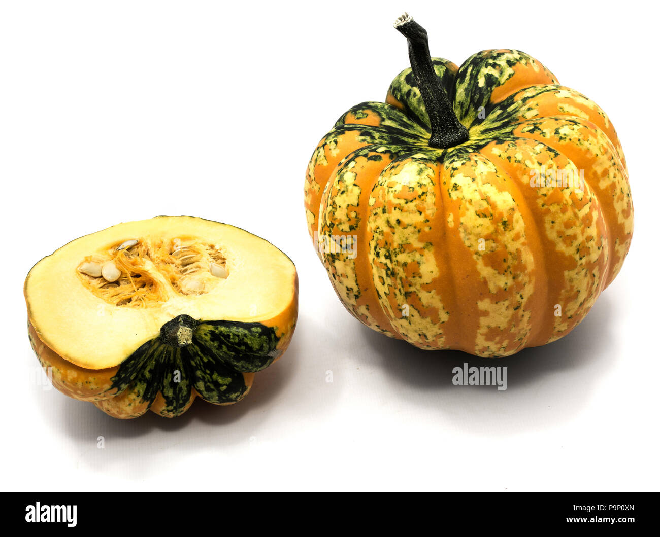 One whole spotted green yellow pumpkin and one half isolated on white ...